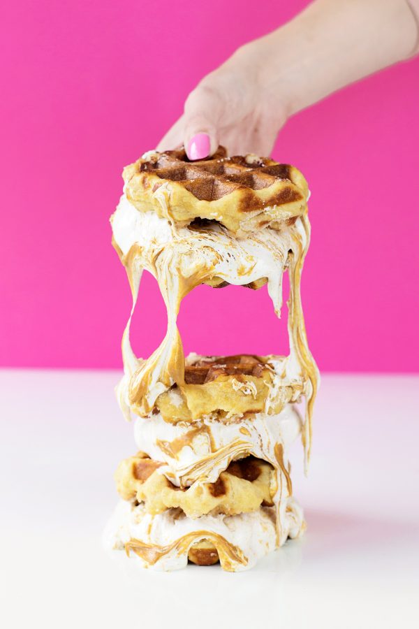 Someone holding waffle sandwiches