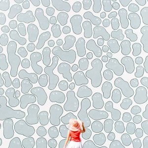 A woman in front of a grey and white wall