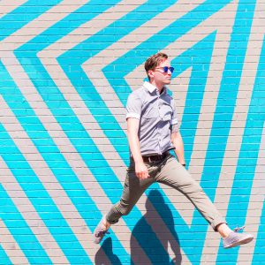 A man in front of a wall with blue stripes