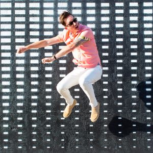 A man in front of a black and white wall
