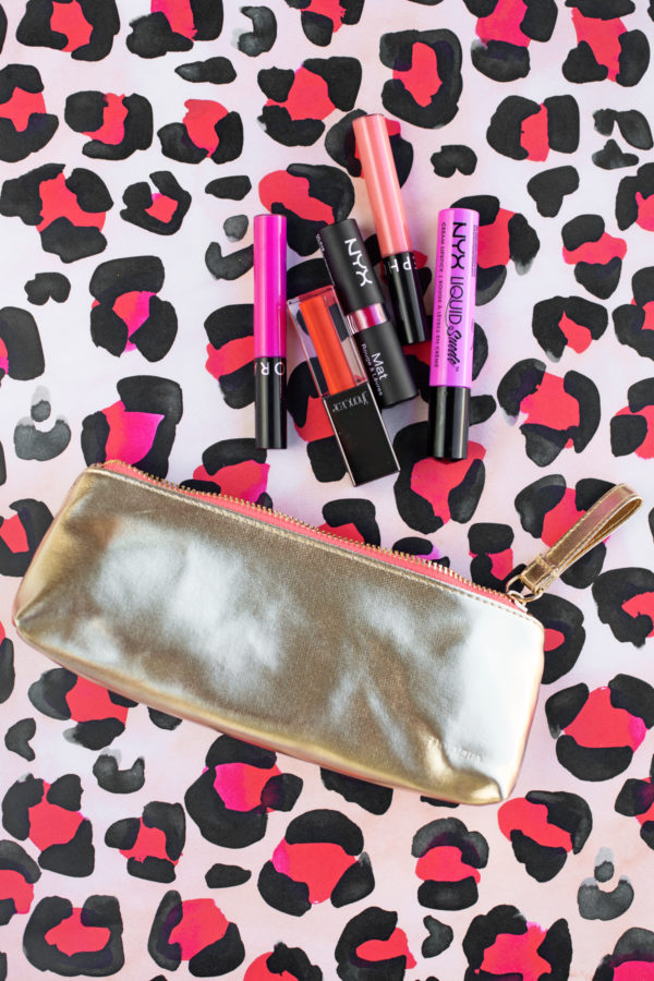 A gold bag with lip sticks in it