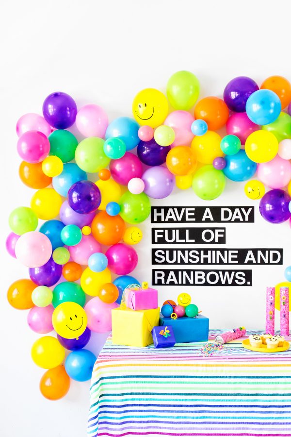 Colorful balloons and a sign with words