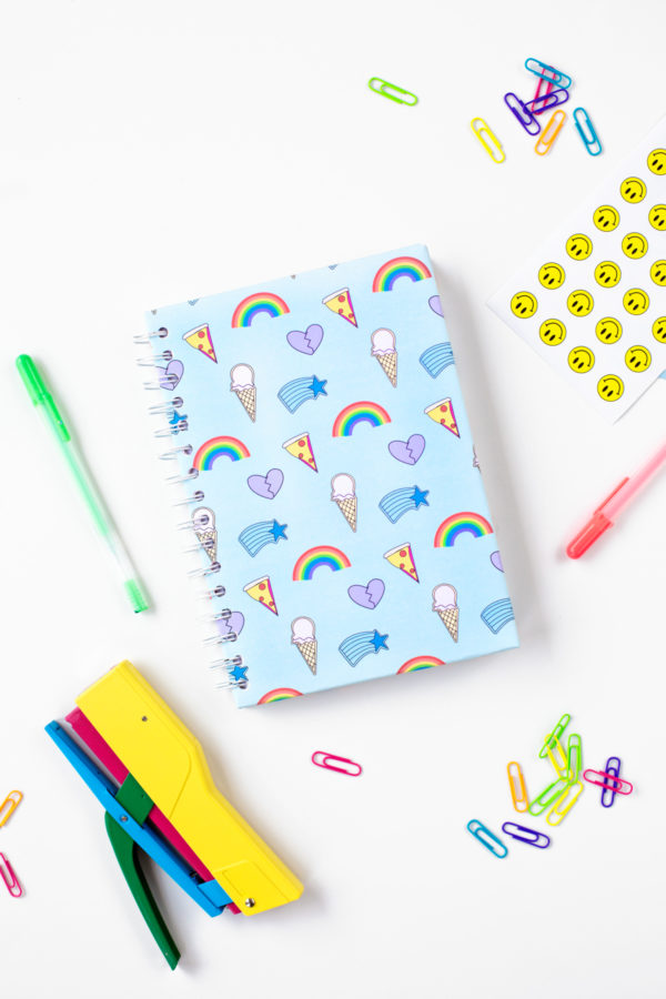 A notebook with rainbow graphics on it