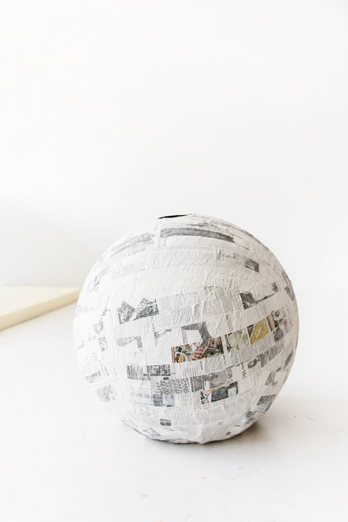 A ball with newspapers glued on it