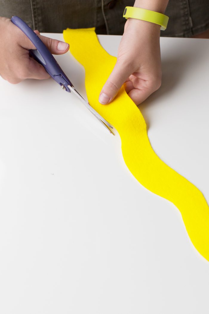 Hot Dog Costume Someone cutting yellow fabric with scissors