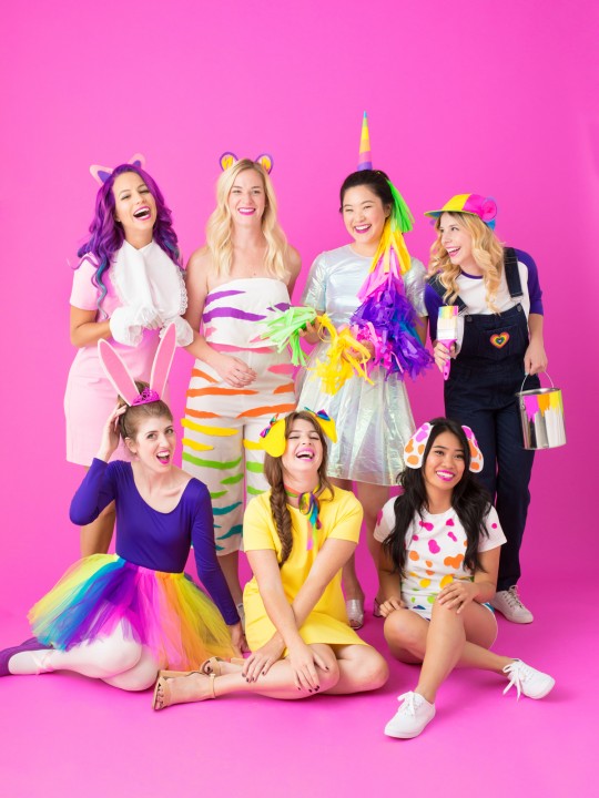 A group of people posing for the camera dressed in costumes