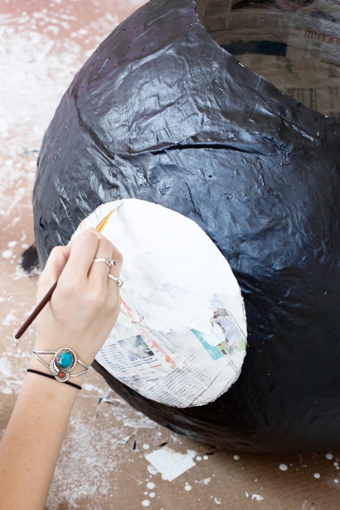Black newspaper wall with white paint