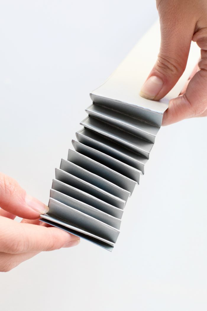 Someone holding a folded paper