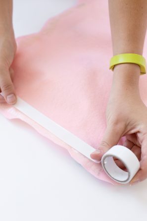 Someone taping pink fabric