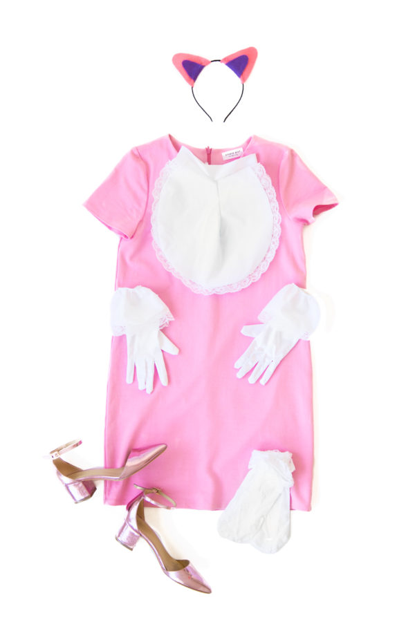 A pink dress with white gloves and beige heels