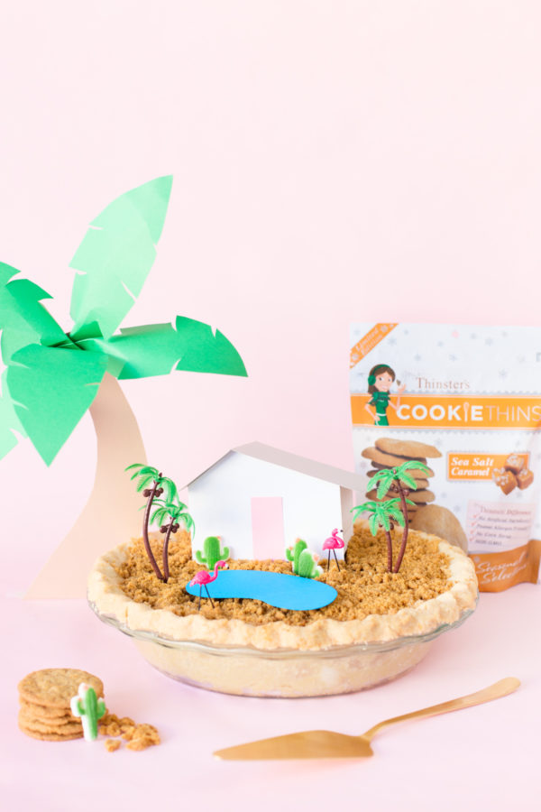 A pie with a fake house and trees on it