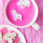 A mug with a pink drink in it