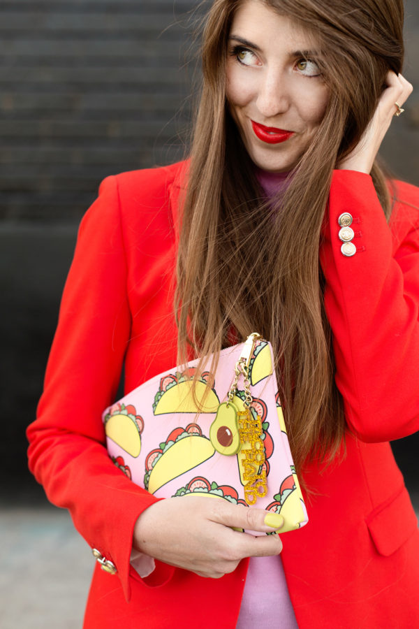 A woman holding a taco clutch