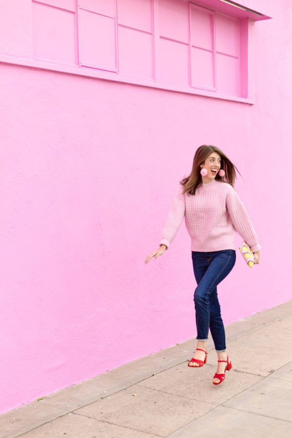 A woman walking down a sidewalk