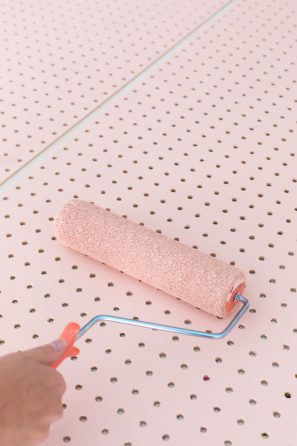 Someone painting wood pink
