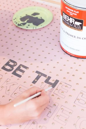 A pink wooden board being painted