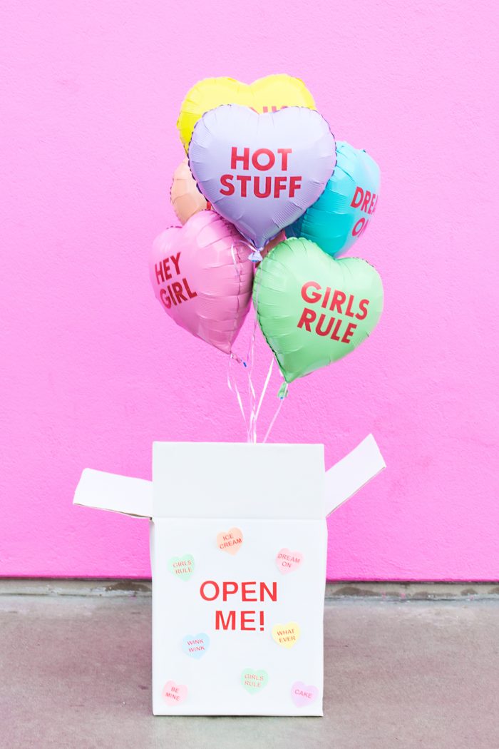 A box with heart-shaped balloons in it