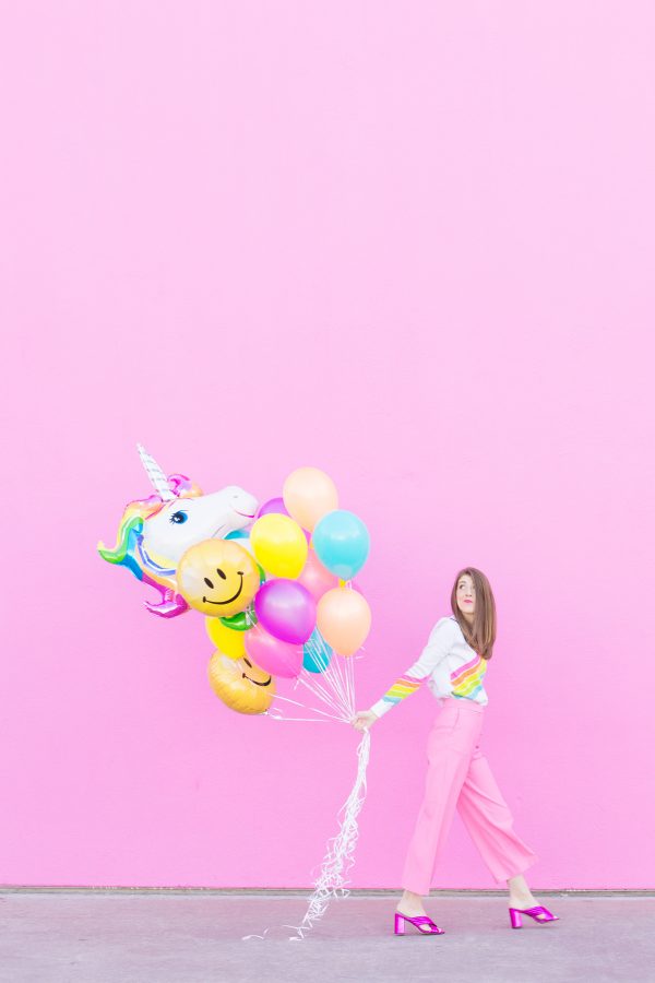 A woman holding balloons