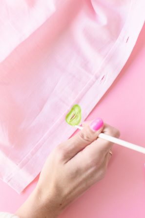 Someone painting green on a shirt