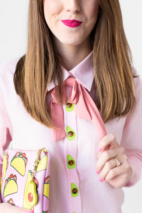 A woman wearing a pink shirt and bow