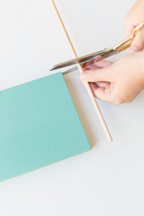 A turquoise board and wooden stick