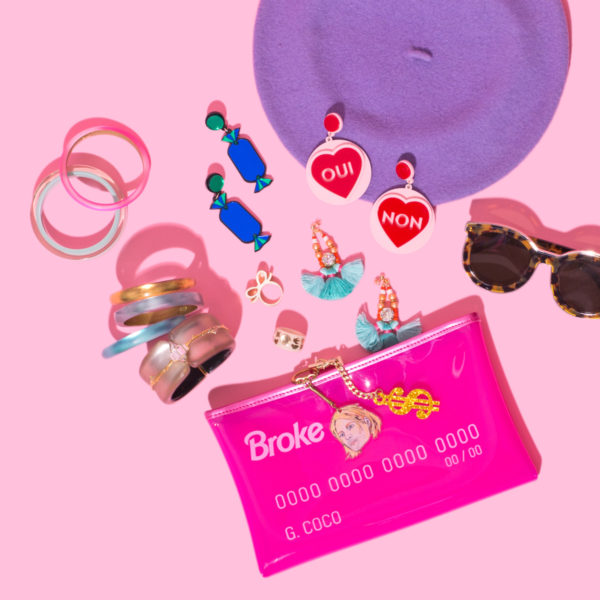 Pink clutch, earrings, and sunglasses