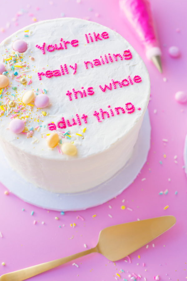 A cake with writing and sprinkles
