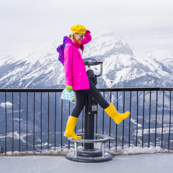 A person standing in front of mountains