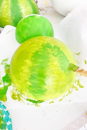 Someone painting a giant fruit