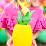 A woman holding a pinapple