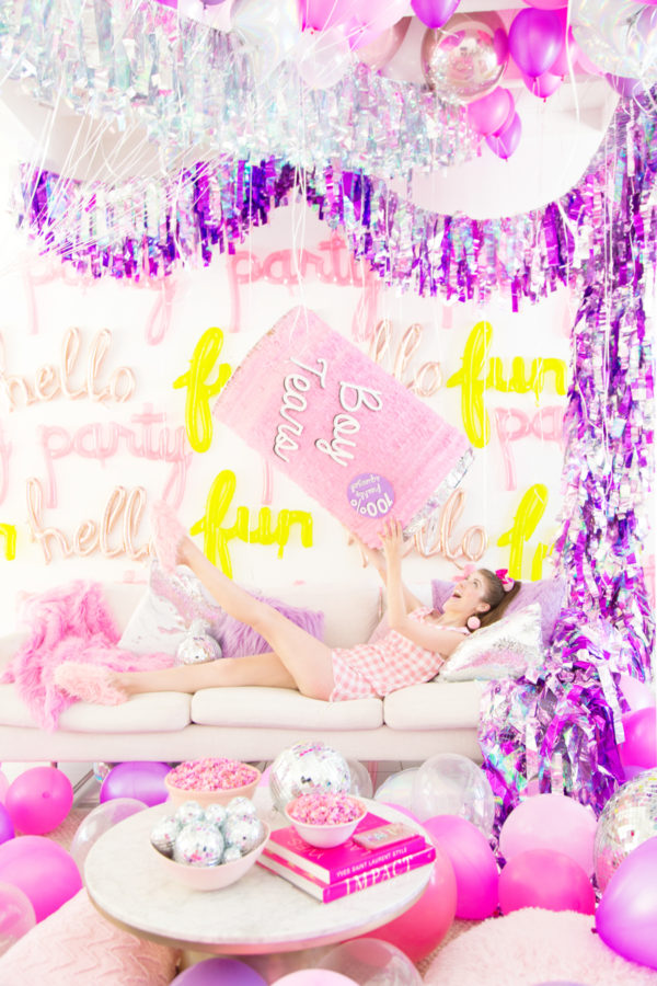 Someone holding a pink pinata 