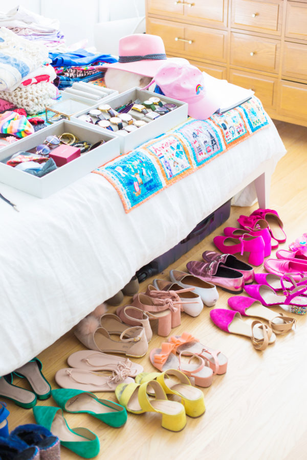 Shoes next to a bed