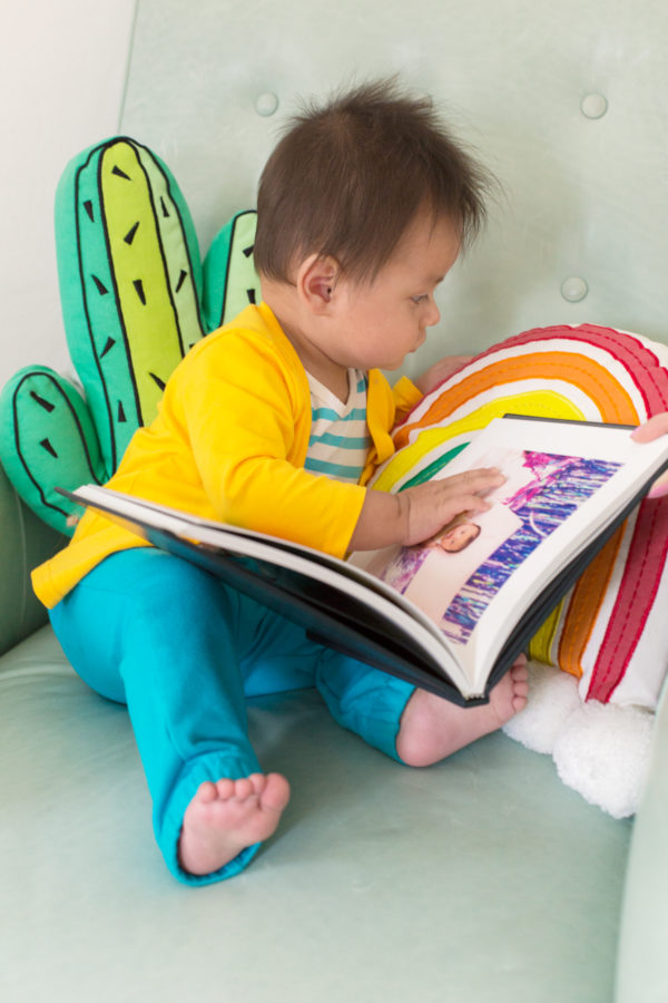 A little boy going through a book