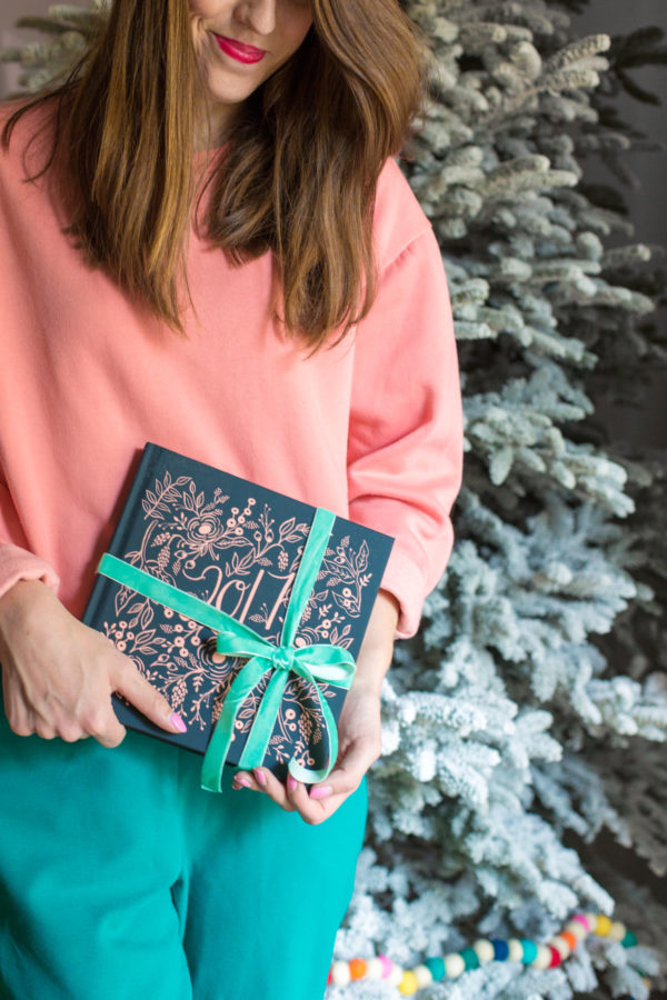 Someone holding a book with ribbon