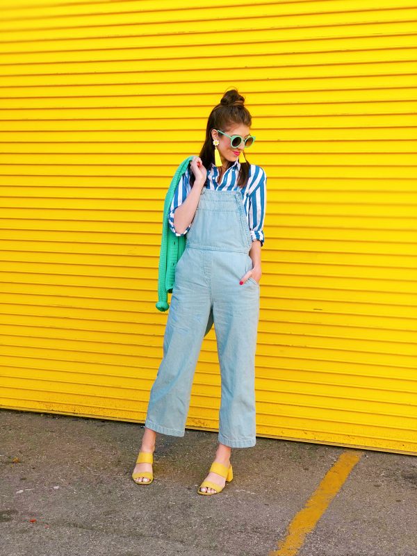 A person standing in front of a yellow wall
