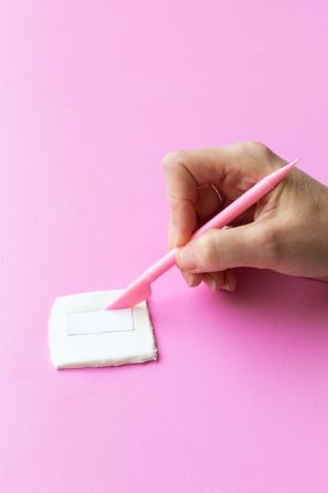 Someone sculpting clay