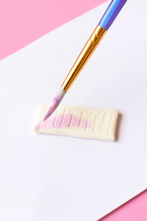 Someone painting clay