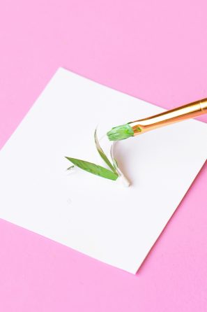 Someone painting paper