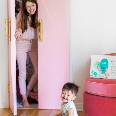 Why We Love Pampers Pure! A woman opening a pink door