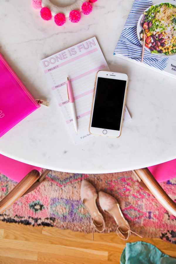 A phone and notepad on a table