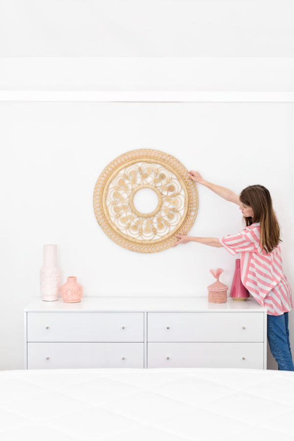 A person holding up a piece of decor