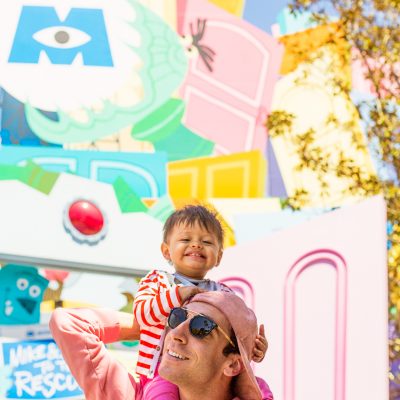 How To Do Disneyland with a One Year Old A little boy on a mans neck