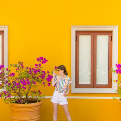 Our Trip to Riviera Maya + Tulum! A person standing in front of a yellow wall