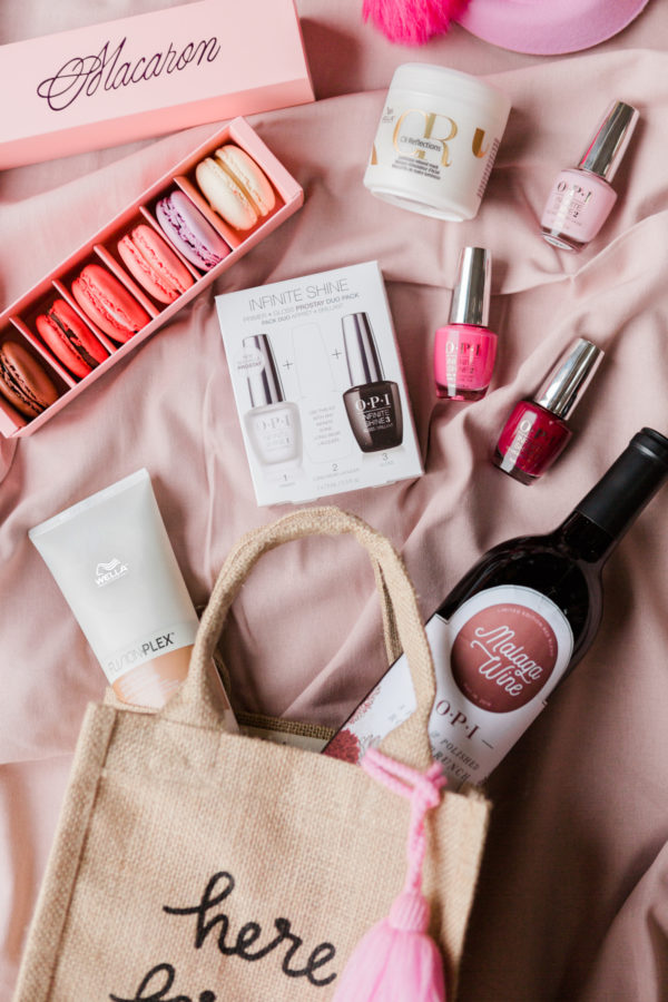 A bag with wine, nail polish, and macaroons