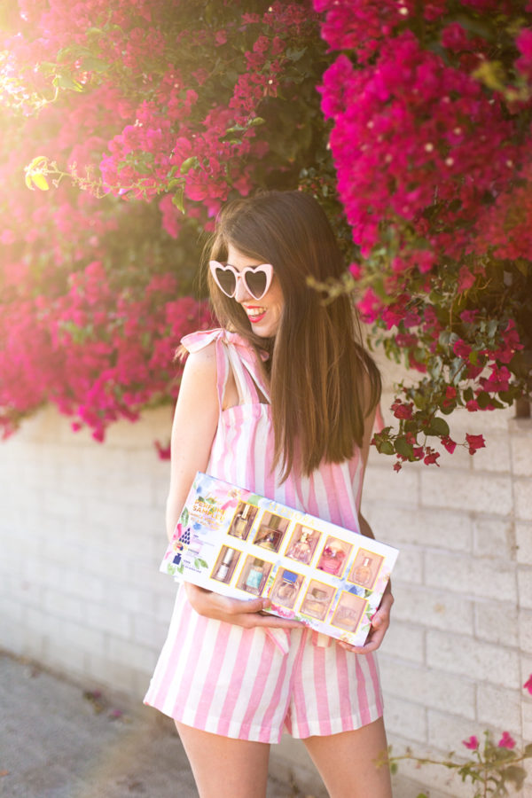 A girl standing in front of flowers