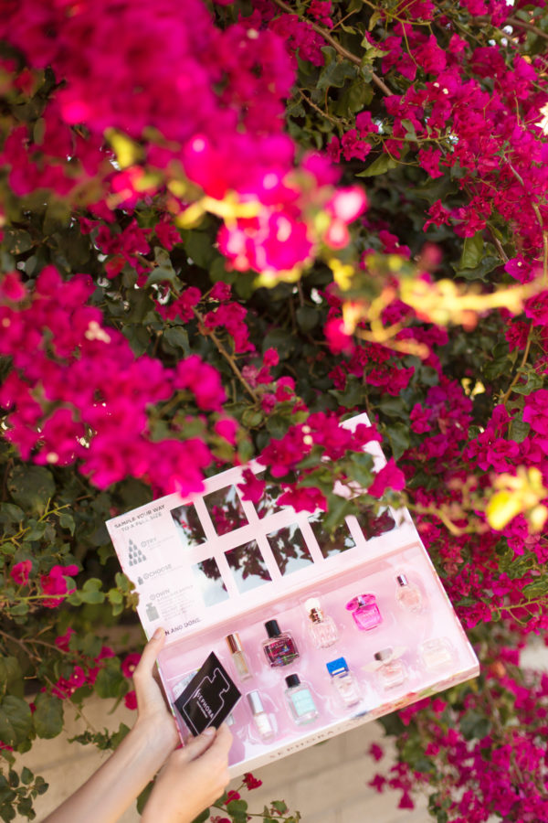 A photo of nail polish next to flowers