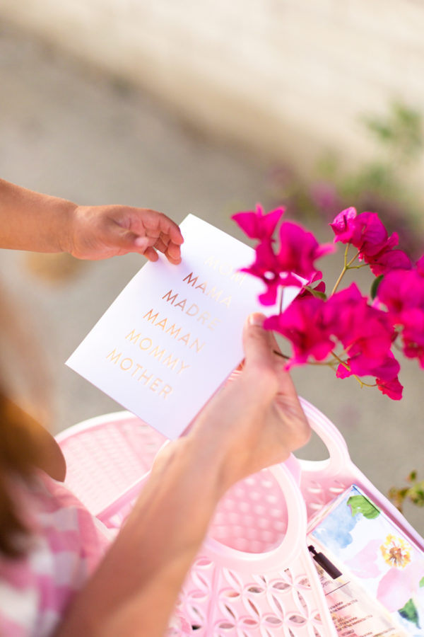 A person holding a card and flowers