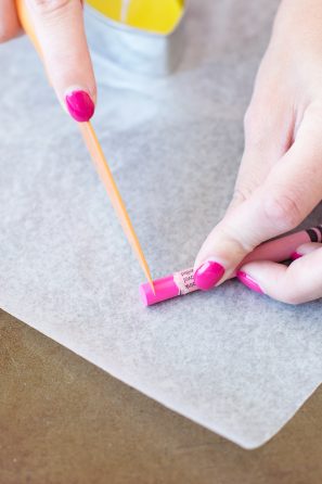 Someone cutting a crayon