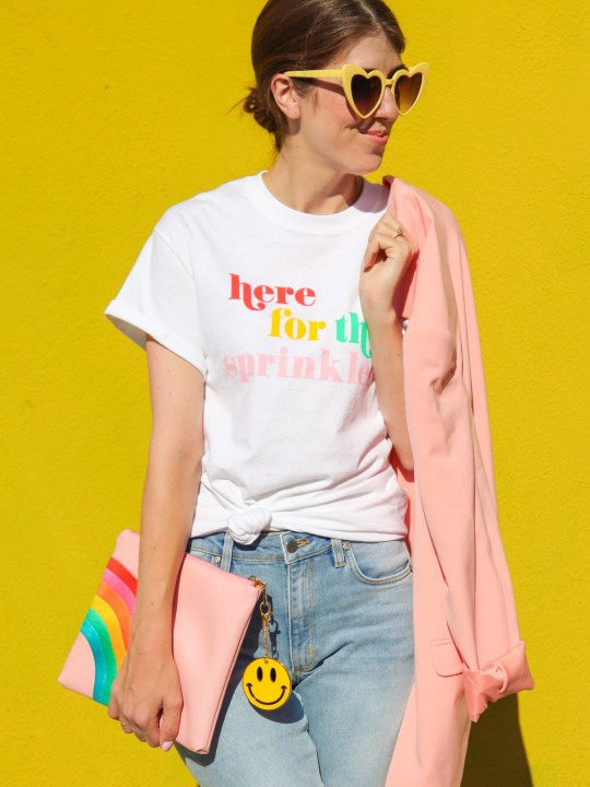 Someone wearing a shirt holding a clutch