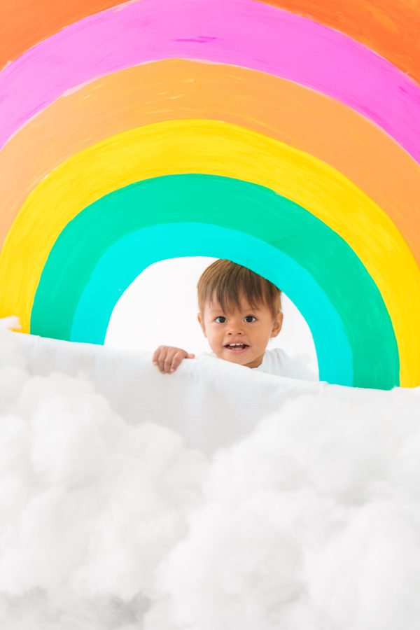 A little boy under a rainbow